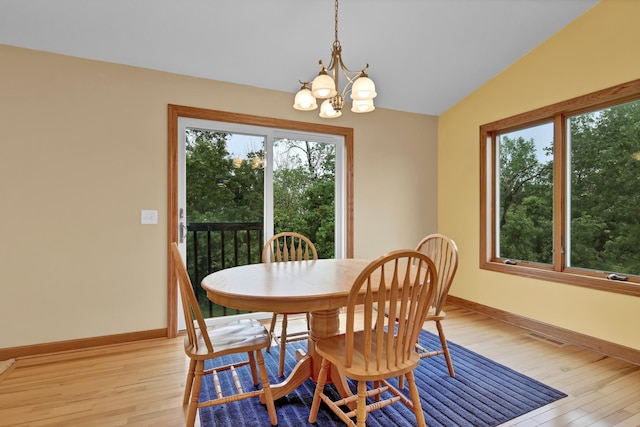 1426 Woodland Way, Lake City, MN 55041 - dining space with plenty of natural light, light wood-style flooring, vaulted ceiling, a chandelier, and baseboards