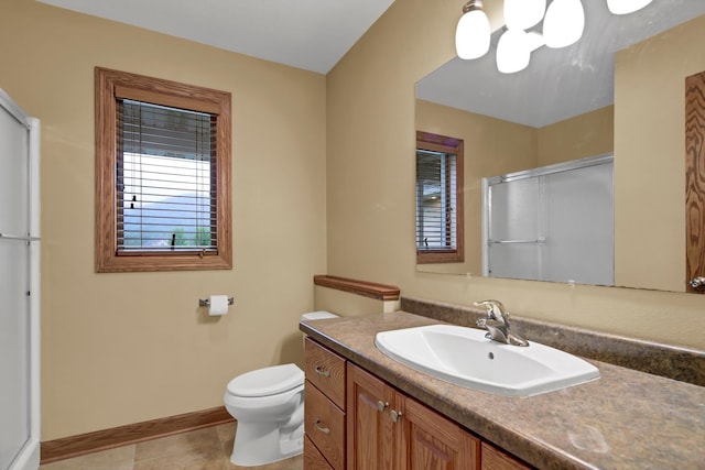 1426 Woodland Way, Lake City, MN 55041 - bathroom with a shower with shower door, vanity, toilet, tile patterned floors, and baseboards