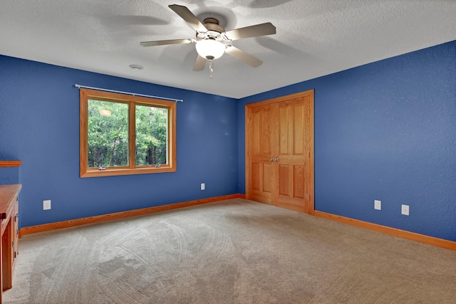 1426 Woodland Way, Lake City, MN 55041 - empty room featuring carpet floors, a ceiling fan, baseboards, and a textured ceiling