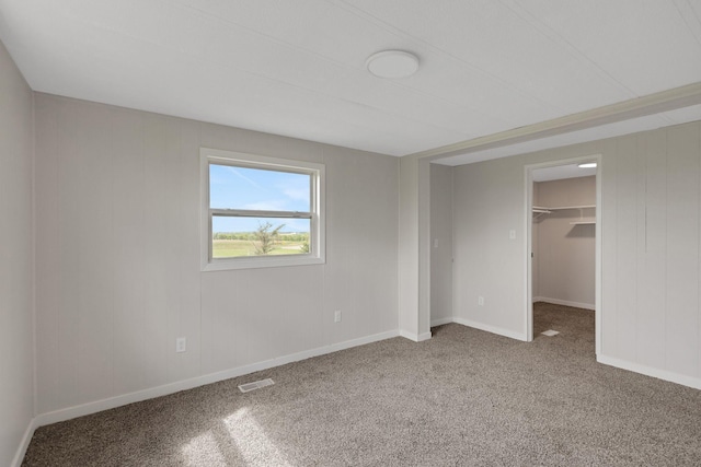 19363 County Road 21, Eden Lake Twp, MN 56368 - unfurnished bedroom with carpet flooring, a spacious closet, baseboards, and a closet