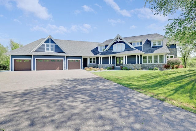 7500 Mark St, Greenfield, MN 55357 - view of front of house featuring a garage, a front yard, driveway, and stone siding