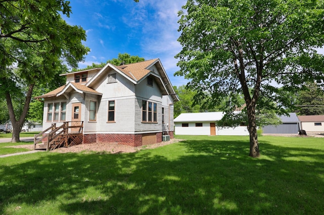 411 6th St, Bird Island, MN 55310 - view of front of home with a front lawn and central AC