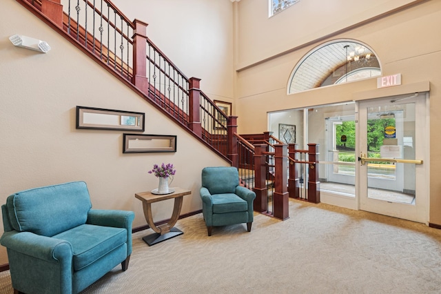 3800 85th Ave N Unit 312, Brooklyn Park, MN 55443 - carpeted foyer entrance with a high ceiling, a chandelier, baseboards, and stairs