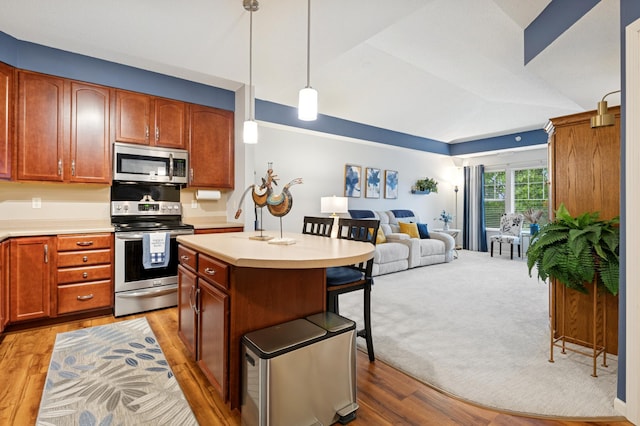 3800 85th Ave N Unit 312, Brooklyn Park, MN 55443 - kitchen with appliances with stainless steel finishes, open floor plan, a breakfast bar area, and light countertops