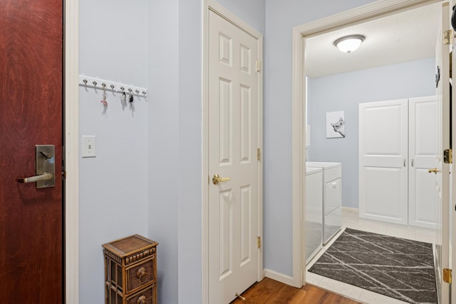 3800 85th Ave N Unit 312, Brooklyn Park, MN 55443 - washroom featuring washer and clothes dryer, wood finished floors, and baseboards