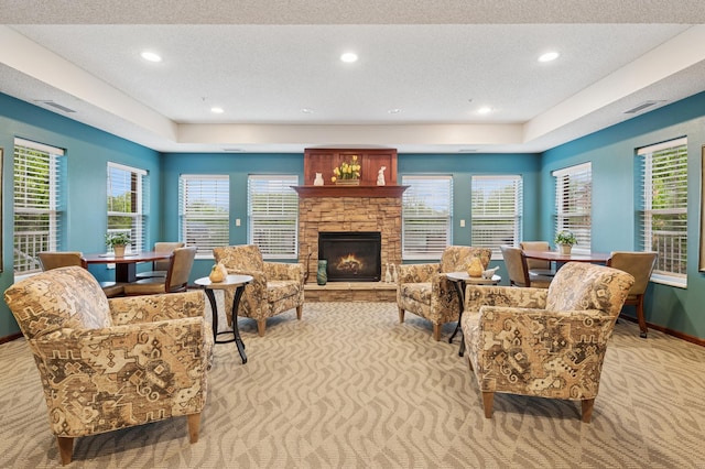 3800 85th Ave N Unit 312, Brooklyn Park, MN 55443 - living area featuring carpet, a raised ceiling, a textured ceiling, a fireplace, and recessed lighting
