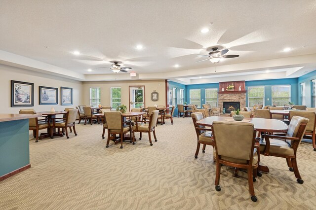 3800 85th Ave N Unit 312, Brooklyn Park, MN 55443 - dining room with ceiling fan, light colored carpet, a stone fireplace, recessed lighting, and healthy amount of natural light