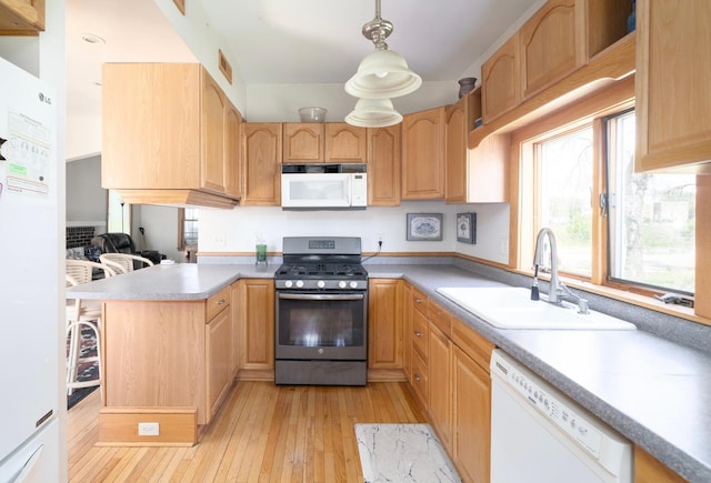 1638 Concordia Ave, Saint Paul, MN 55104 - kitchen featuring white appliances, a sink, light wood finished floors, a peninsula, and hanging light fixtures