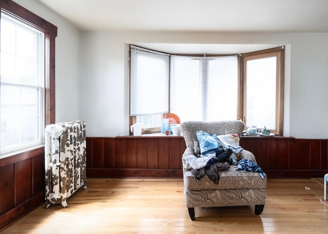 1638 Concordia Ave, Saint Paul, MN 55104 - sitting room with light wood finished floors and a wainscoted wall