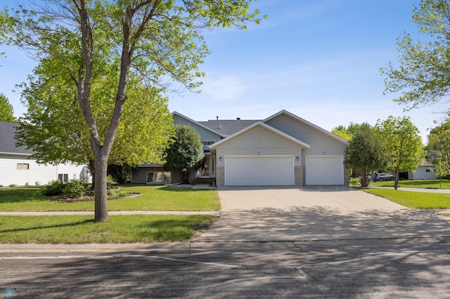 3138 25th Ave S, Fargo, ND 58103 - view of front of house with driveway, an attached garage, a front yard, and brick siding