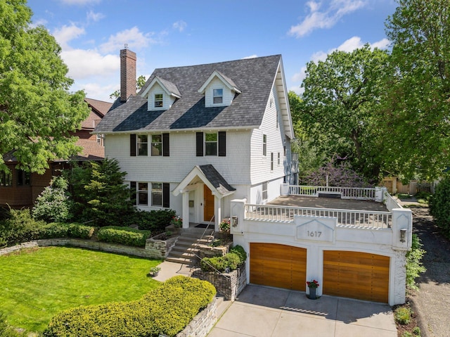 1617 Franklin Ave, Minneapolis, MN 55405 - view of front of home with a garage, concrete driveway, a front yard, a chimney, and roof with shingles