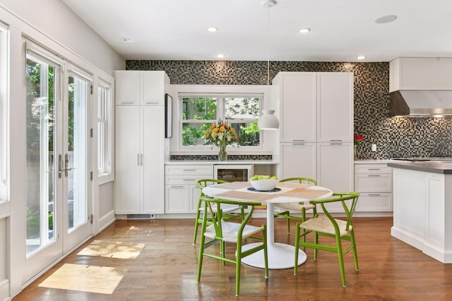 1617 Franklin Ave, Minneapolis, MN 55405 - kitchen with wall chimney range hood, healthy amount of natural light, white cabinets, decorative backsplash, and recessed lighting