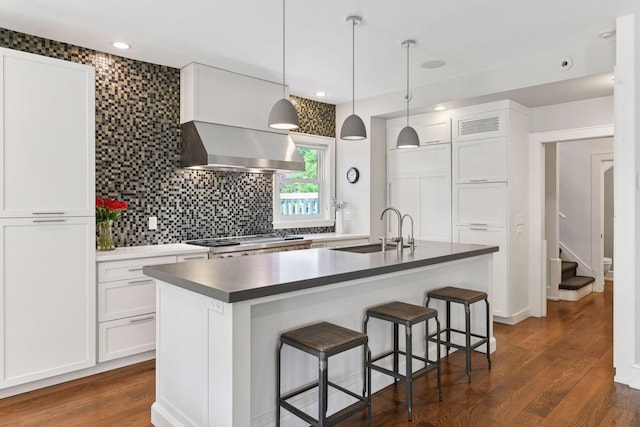 1617 Franklin Ave, Minneapolis, MN 55405 - kitchen featuring a sink, wall chimney exhaust hood, range, dark wood-style floors, and white cabinets