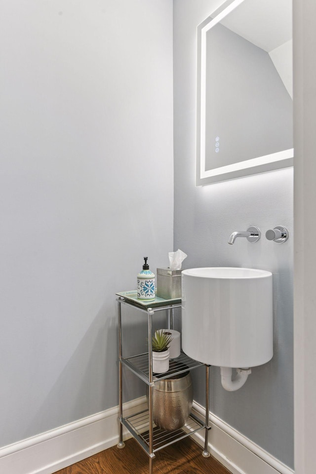 1617 Franklin Ave, Minneapolis, MN 55405 - bathroom featuring baseboards, wood finished floors, and a sink