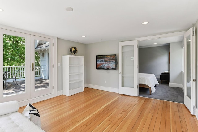 1617 Franklin Ave, Minneapolis, MN 55405 - unfurnished living room featuring baseboards, light wood-style flooring, recessed lighting, and french doors