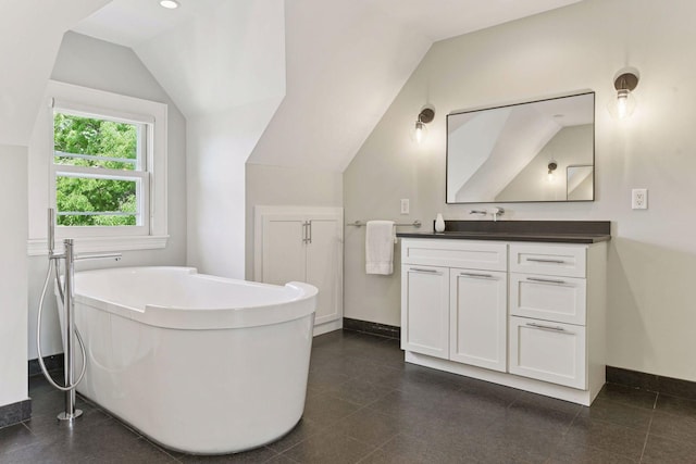 1617 Franklin Ave, Minneapolis, MN 55405 - bathroom featuring vaulted ceiling, vanity, a freestanding bath, and baseboards