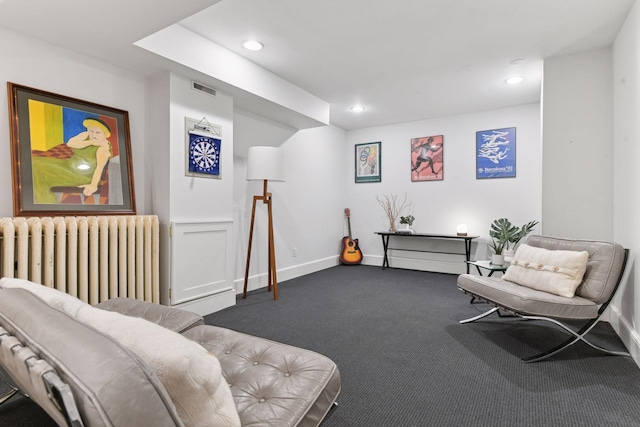 1617 Franklin Ave, Minneapolis, MN 55405 - living room featuring radiator heating unit, dark carpet, recessed lighting, and baseboards
