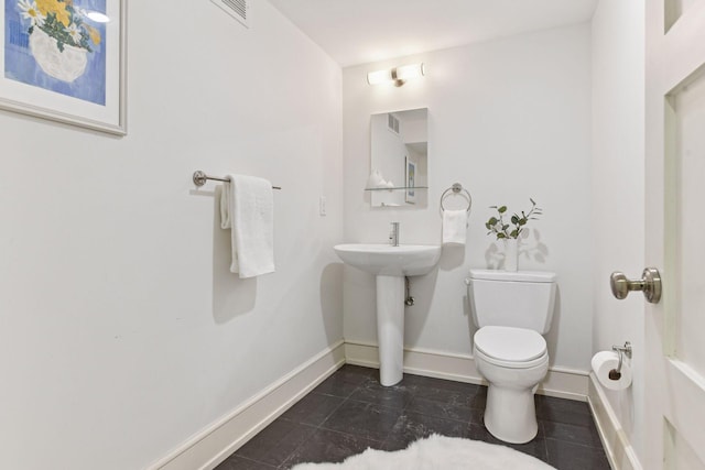 1617 Franklin Ave, Minneapolis, MN 55405 - bathroom with toilet, baseboards, and tile patterned floors