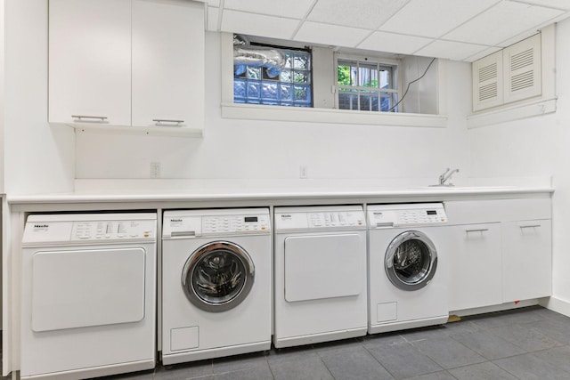 1617 Franklin Ave, Minneapolis, MN 55405 - laundry area with washing machine and clothes dryer, tile patterned flooring, and cabinet space
