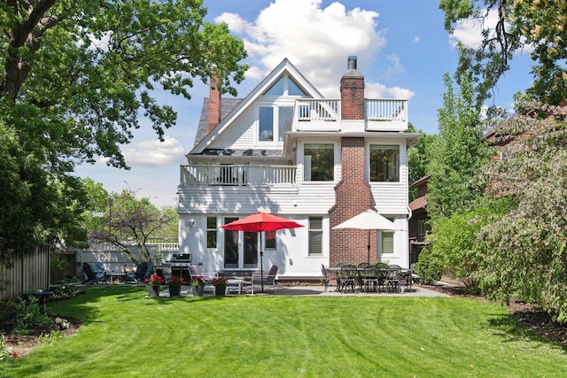 1617 Franklin Ave, Minneapolis, MN 55405 - back of house featuring a balcony, a chimney, and a patio