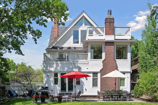 1617 Franklin Ave, Minneapolis, MN 55405 - rear view of house featuring a balcony, a chimney, entry steps, and a patio