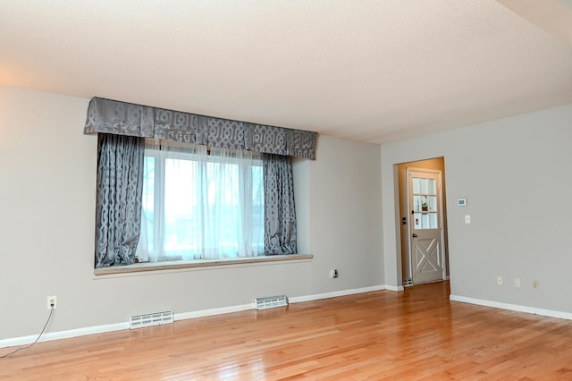 2904 Silver Lake Ct NE, Saint Anthony, MN 55421 - spare room featuring wood finished floors and baseboards