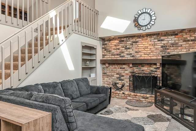 2904 Silver Lake Ct NE, Saint Anthony, MN 55421 - living room featuring built in shelves, a fireplace, and stairs