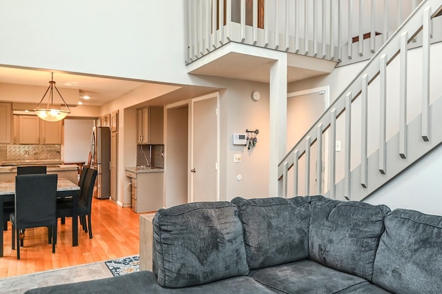 2904 Silver Lake Ct NE, Saint Anthony, MN 55421 - living room with a towering ceiling, light wood finished floors, and stairway
