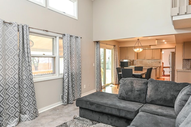 2904 Silver Lake Ct NE, Saint Anthony, MN 55421 - living room featuring a high ceiling and baseboards