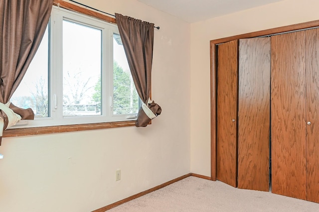 2904 Silver Lake Ct NE, Saint Anthony, MN 55421 - unfurnished bedroom with carpet flooring, a closet, and baseboards