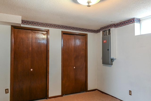 2904 Silver Lake Ct NE, Saint Anthony, MN 55421 - unfurnished bedroom with electric panel, light carpet, a textured ceiling, multiple closets, and baseboards
