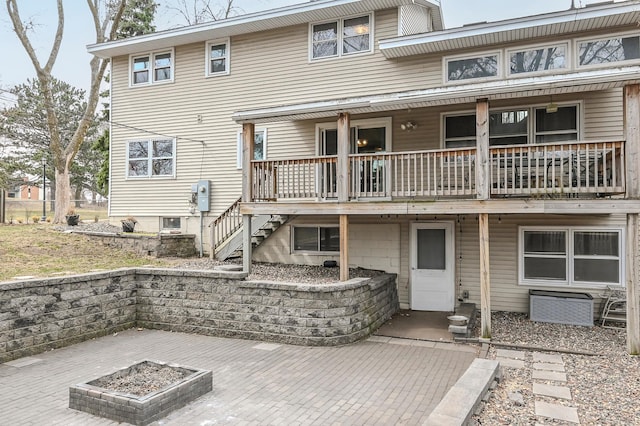 2904 Silver Lake Ct NE, Saint Anthony, MN 55421 - rear view of house with stairway, an outdoor fire pit, and a wooden deck