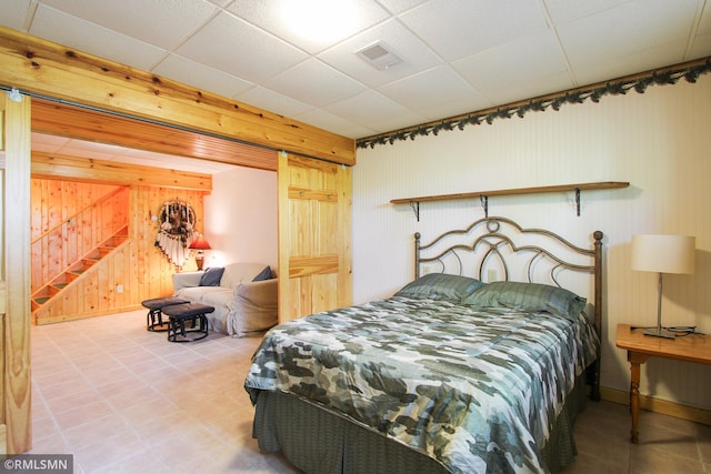 49734 202nd Pl, Mcgregor, MN 55760 - bedroom with wooden walls, baseboards, tile patterned floors, and a drop ceiling
