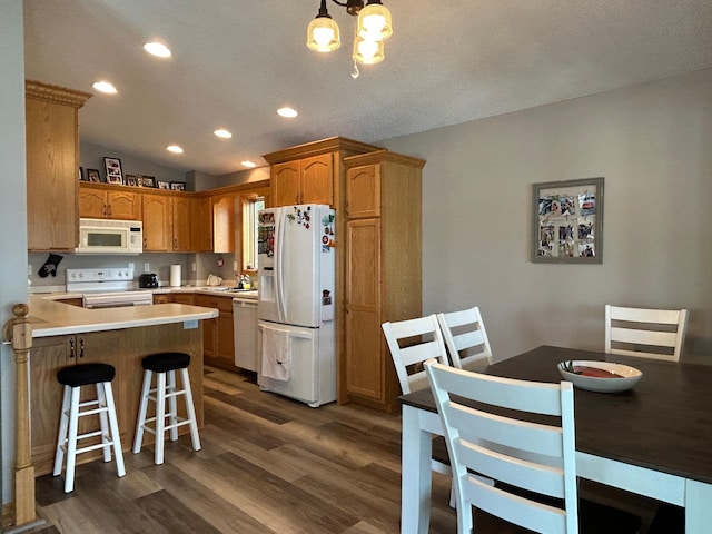 33617 Charlie Trapp Rd, Dent, MN 56528 - kitchen featuring white appliances, a peninsula, dark wood-type flooring, light countertops, and recessed lighting