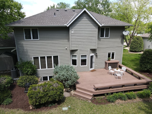 1212 Mill Creek Cir, Saint Cloud, MN 56303 - back of house with a shingled roof, a deck, and a storage unit