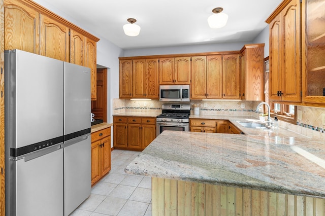 1212 Mill Creek Cir, Saint Cloud, MN 56303 - kitchen featuring stainless steel appliances, tasteful backsplash, a peninsula, and light tile patterned flooring
