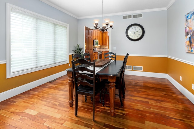1212 Mill Creek Cir, Saint Cloud, MN 56303 - dining area with a chandelier, light wood-style flooring, and crown molding