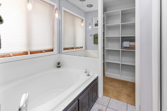 1212 Mill Creek Cir, Saint Cloud, MN 56303 - bathroom with a garden tub, tile patterned floors, and a spacious closet