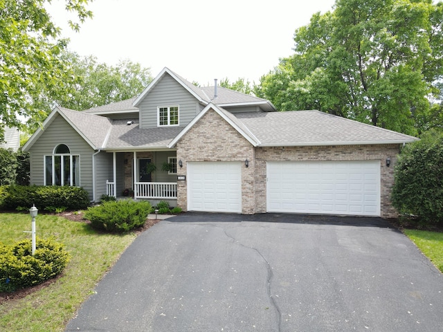 1212 Mill Creek Cir, Saint Cloud, MN 56303 - traditional home with asphalt driveway, a garage, a porch, a shingled roof, and brick siding