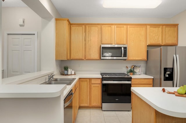 13872 52nd Ave N, Plymouth, MN 55446 - kitchen featuring stainless steel appliances, light countertops, light tile patterned flooring, a sink, and a peninsula