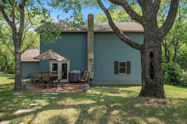 12801 40th St NE, Saint Michael, MN 55376 - back of property with a yard, a patio, a chimney, and french doors