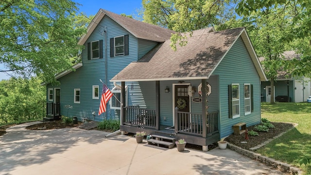 12801 40th St NE, Saint Michael, MN 55376 - view of front of home with a shingled roof, a porch, a front lawn, and a patio area