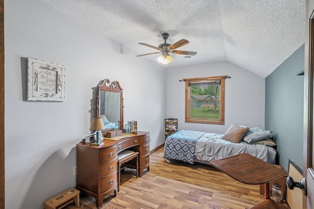 12801 40th St NE, Saint Michael, MN 55376 - bedroom featuring a textured ceiling, light wood-style flooring, vaulted ceiling, and a ceiling fan