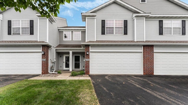 16895 78th Pl N, Maple Grove, MN 55311 - townhome / multi-family property featuring a garage, brick siding, driveway, and roof with shingles