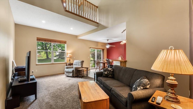 16895 78th Pl N, Maple Grove, MN 55311 - carpeted living area featuring a ceiling fan, a towering ceiling, and baseboards
