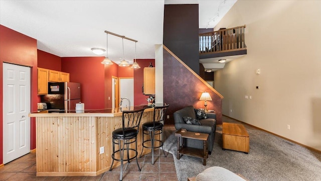 16895 78th Pl N, Maple Grove, MN 55311 - kitchen featuring freestanding refrigerator, a sink, a kitchen breakfast bar, a peninsula, and light brown cabinets