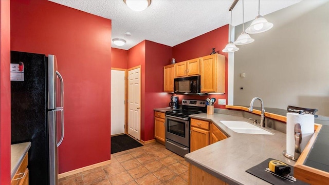 16895 78th Pl N, Maple Grove, MN 55311 - kitchen with appliances with stainless steel finishes, a sink, pendant lighting, a textured ceiling, and baseboards