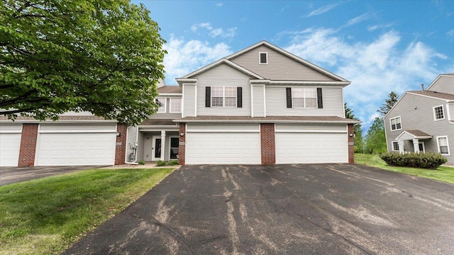 16895 78th Pl N, Maple Grove, MN 55311 - view of front of house with asphalt driveway, brick siding, and a garage