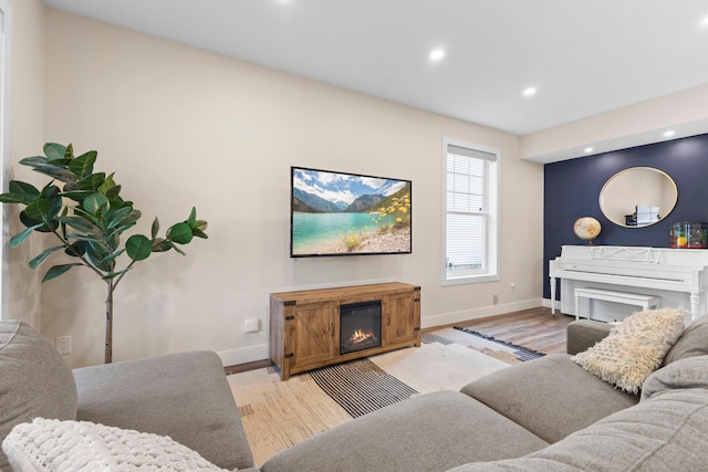 11955 84th Pl N, Maple Grove, MN 55369 - living room with baseboards, a glass covered fireplace, recessed lighting, and light wood finished floors