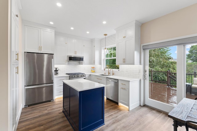 11955 84th Pl N, Maple Grove, MN 55369 - kitchen with stainless steel appliances, a sink, backsplash, light countertops, and recessed lighting